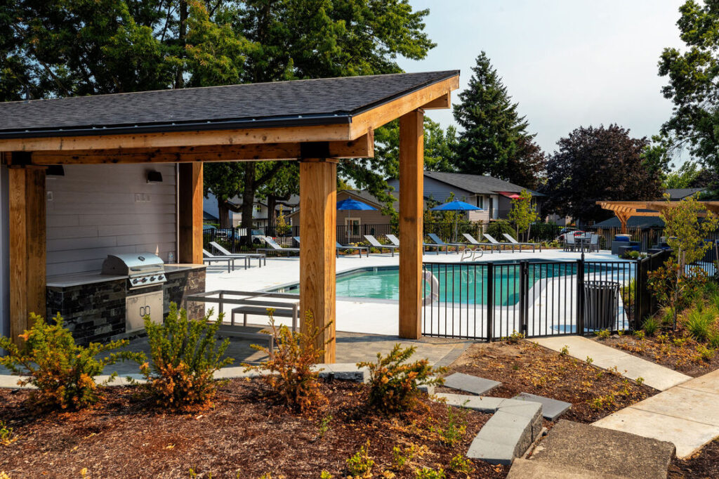 Outdoor BBQ area and deck with view of the pool