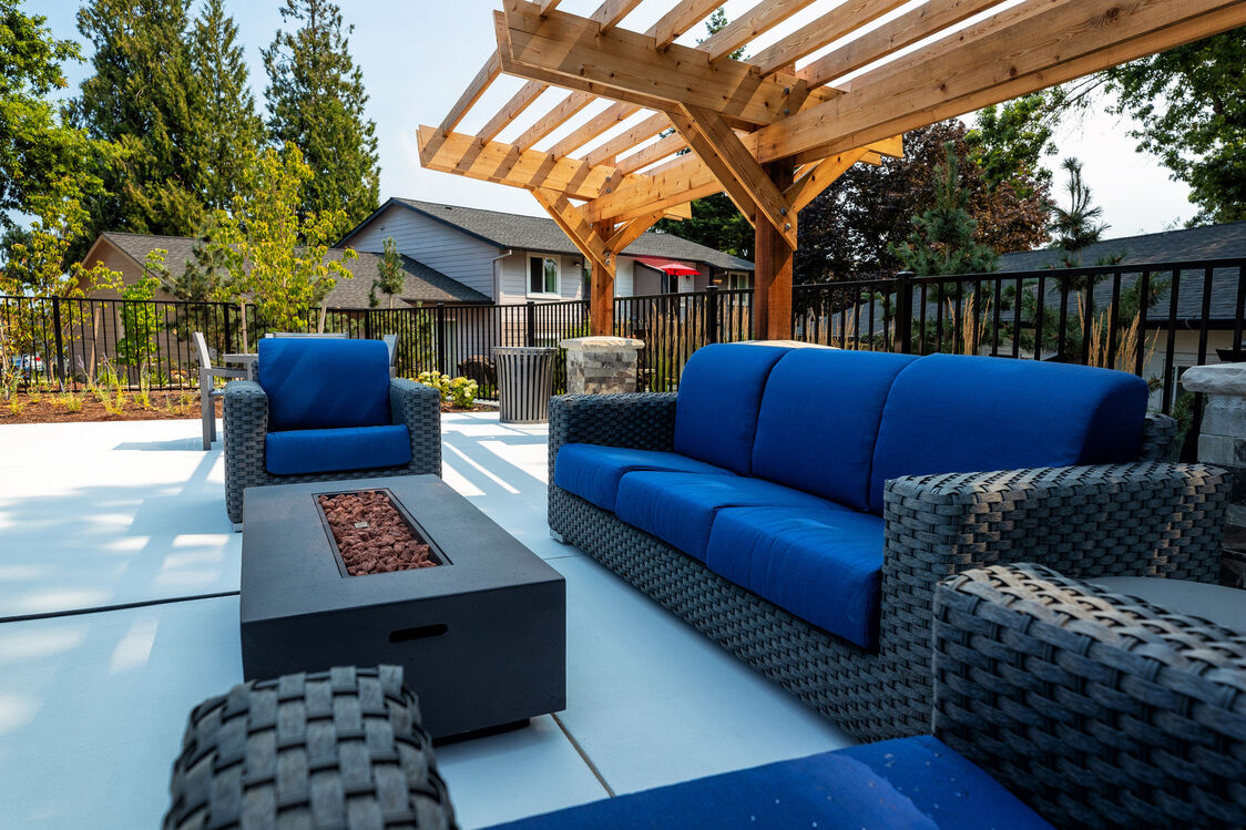 Blue outdoor furniture next to a pool