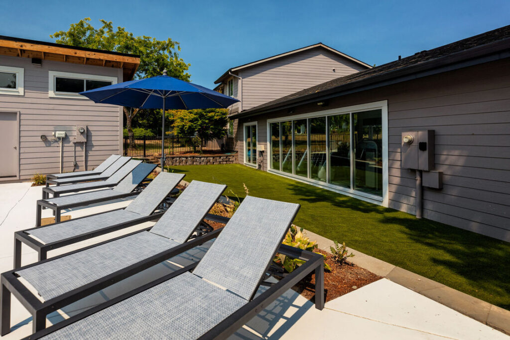 reclining pool chairs and umbrellas